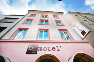 a building with a sign on the side of it at b-smart motel Basel in Basel