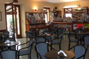 a restaurant with tables and chairs in a room at Azzano Holidays B&B in Mezzegra