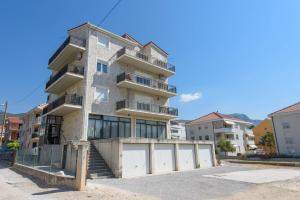 a tall apartment building with a white garage at Luxury Rooms Ivana in Kaštela