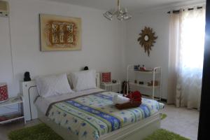 a bedroom with a bed in a white room at Casa Teresinha in Sesimbra +172 photos