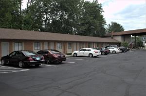 um grupo de carros estacionados num parque de estacionamento em Carrier Motor Lodge em Newington