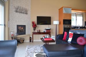 a living room with a blue couch and a fireplace at Cantinho da Bela Vista in Porto Judeu