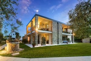 a large house with a lawn in front of it at Casaliva Relais in Bardolino
