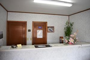 an office with a reception desk with flowers on it at Economy Inn in Taylorville