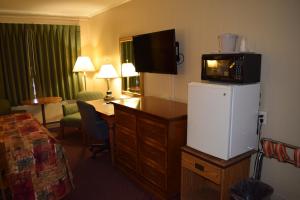 a hotel room with a microwave on top of a refrigerator at Economy Inn in Taylorville