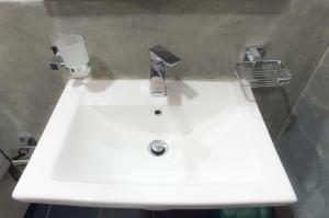 a white sink with a cup on top of it at First House Mihintale in Mihintale