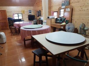 a room with tables and chairs in a restaurant at Jin Zu Cottage in Lugu Lake