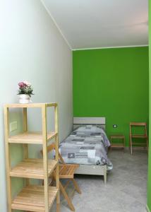 a bedroom with a bed with a green wall at B&B Masseria Cozzi in Lauria Inferiore
