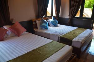 Postel nebo postele na pokoji v ubytování Coco Bungalows Hoi An