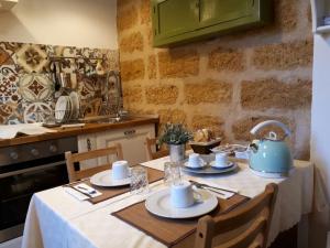 a kitchen with a table with a blue tea kettle on it at AL-ZABUT in Sambuca di Sicilia