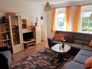 a living room with a couch and a coffee table at Ferienwohnungen "Am Schlössel" in Kurort Oberwiesenthal