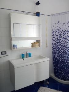 a white bathroom with a sink and a shower at Terramadre in Itri