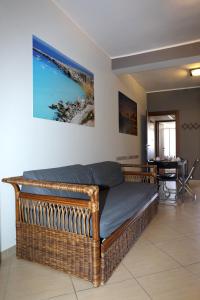 a large wicker bed in a room with a table at Conte Agostino Pepoli in Trapani