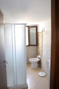 a bathroom with a toilet and a sink at Conte Agostino Pepoli in Trapani