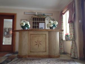 ein Zimmer mit einem Tisch mit Blumen darauf in der Unterkunft Gästehaus Meran in Bad Wiessee