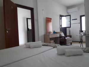 a bedroom with a bed with two pillows on it at Marina's Rooms in Larnaca