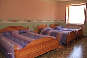 Postel nebo postele na pokoji v ubytování Agriturismo La Praduscella