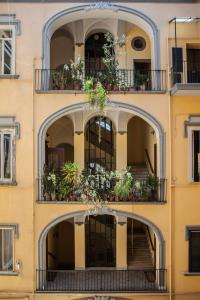 an apartment building with balconies and potted plants at SuperOtium in Naples