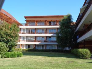 an apartment building with a lawn in front of it at Apartment Maja Moravske Toplice in Moravske Toplice
