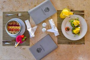 a table with two plates of food and a bowl of food at Sumberkima Hill 1 in Pemuteran
