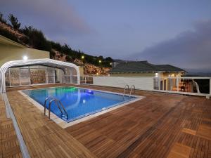a swimming pool on the deck of a house at White Suites in Majdal Shams