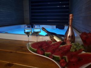 a plate of fruit and two glasses of wine at La Vela Luxury in Trogir