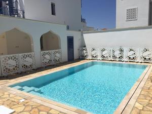 a large swimming pool with blue water in a building at TorreBlu Residence in Torre Lapillo