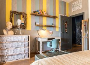 a bedroom with a bed and a desk and a mirror at Guest house Trevignano Romano in Trevignano Romano