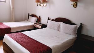 a hotel room with two beds and a telephone at Evergreen Hotel in Antananarivo