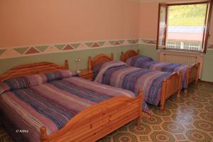 Postel nebo postele na pokoji v ubytování Agriturismo La Praduscella