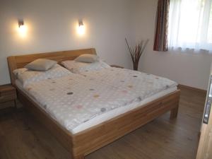 a bedroom with a bed with a wooden frame at Appartement Waldblick in Leogang