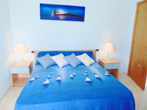 a large blue bed with three boats on it at Villa Antonio Calderisi in Vieste