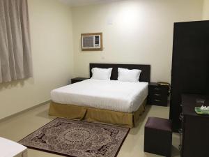מיטה או מיטות בחדר ב-رفيف الشمال - الحائط Rafeef Al Shamal