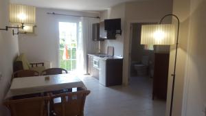 a kitchen and dining room with a table and a room with a tableablish at Apartamentos Hacienda de Arna in Somo