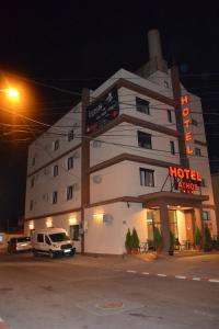 a hotel with a car parked in front of it at Hotel Athos in Bucharest