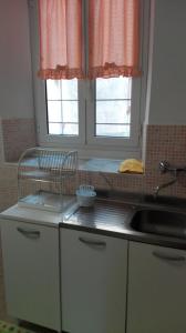 A kitchen or kitchenette at Appartamenti La Quiete
