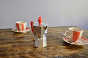 a candle in a holder on a table with two cups at Casina dello Zio in Verbania