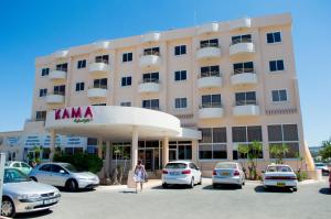 a building with cars parked in front of it at Apartment nearby Golden Coast in Protaras