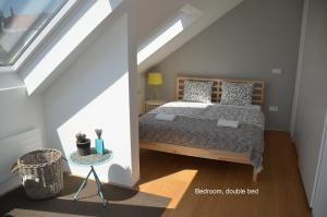 a bedroom with a bed in a attic at i Design Apartment in Ljubljana