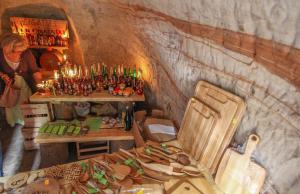 a bar with a table and chairs in a cave at Ligatne Homestay in Līgatne