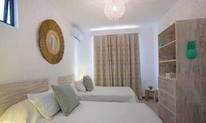 a bedroom with two beds and a mirror on the wall at Marosalie in Pereybere +22 photos