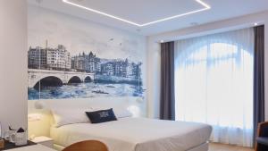 a hotel room with a painting on the wall at Boulevart Donostia in San Sebastián