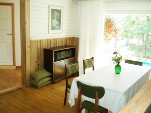a dining room with a table and a stove at Villa Lille in Pärnu