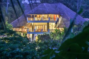 a house in the middle of a forest at night at The Manipura Luxury Estate and Spa Up to 18 person, fully serviced in Ubud