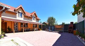 a courtyard of a house with a fence at Vila Nico in Haţeg