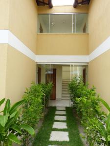 a building with a walkway in front of it at Varandas da Praia Apartamentos in Porto Seguro