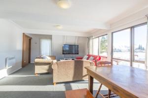 a living room with a couch and a table at Arosa - Lake Tekapo in Lake Tekapo