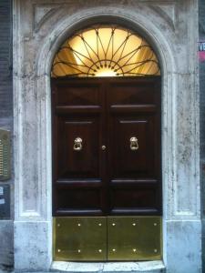 a large wooden door with a window in a building at Urbana 33 in Rome