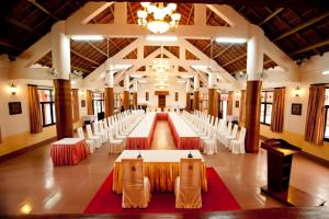 a large banquet hall with white tables and chairs at Dam San Hotel in Buon Ma Thuot