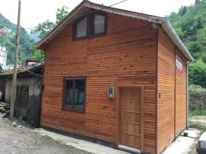 a wooden cabin with a door in front at Caykara Uzungol Bungalow in Uzungol